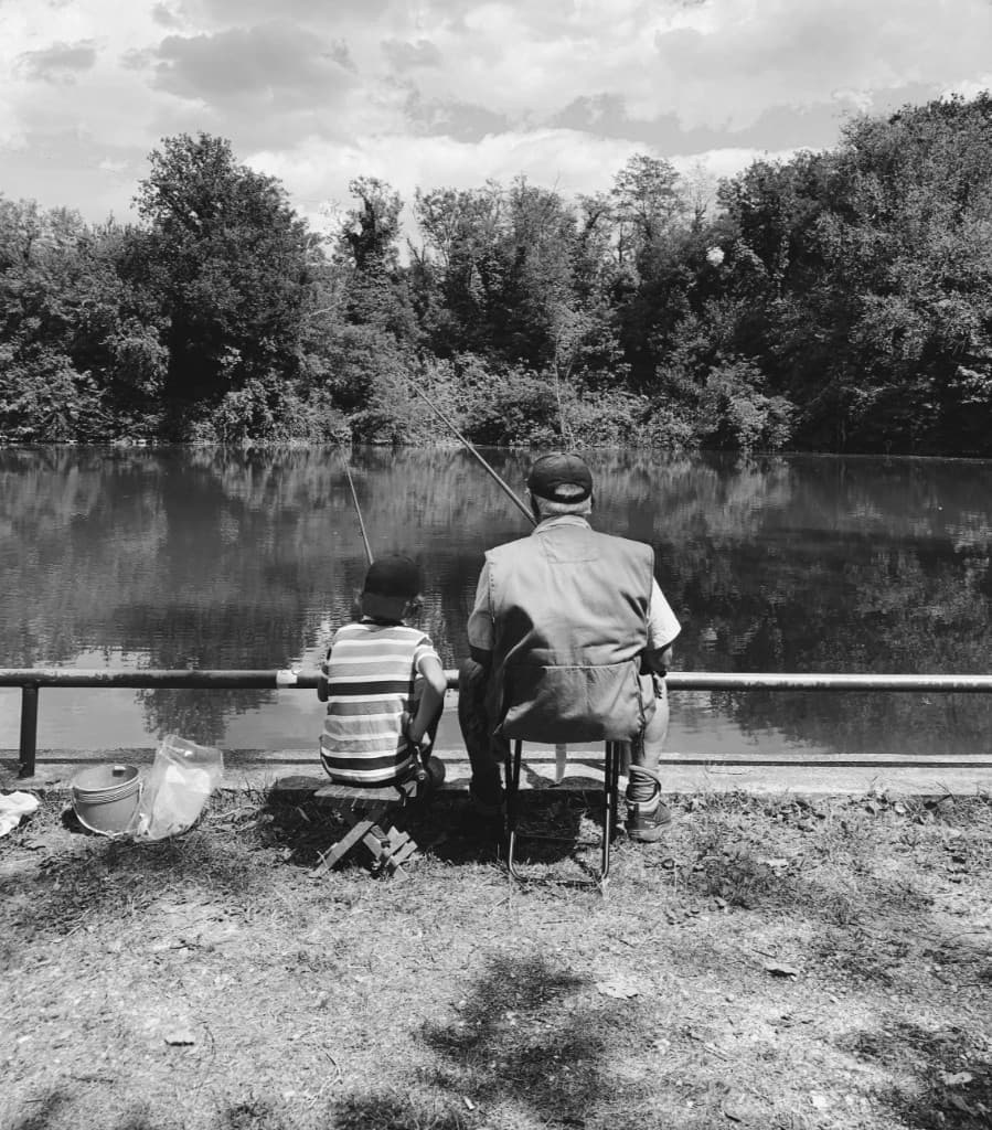 Grandfather and grandson fishing
